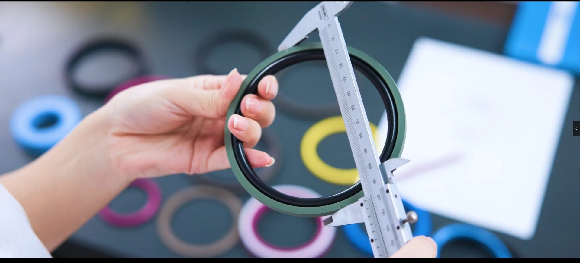 Hydraulic seal undergoing dimensional inspection with calipers